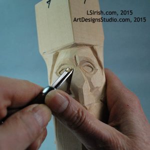 carving the eye lids of a wood spirit