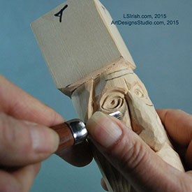 Using a small round gouge in wood spirit carving
